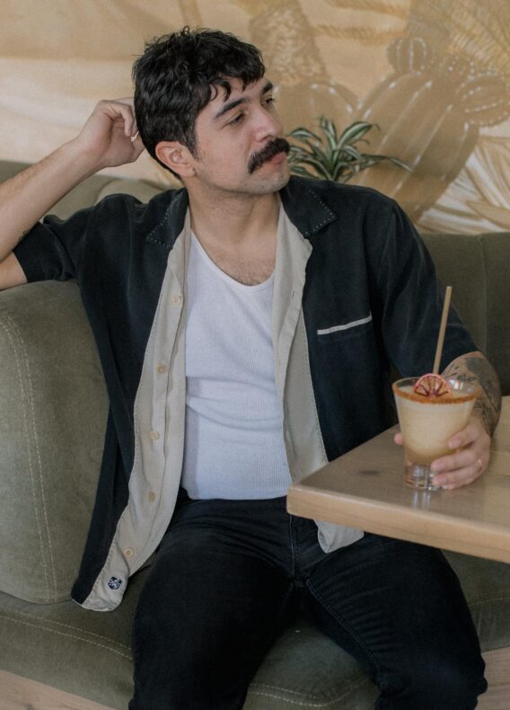 Man sitting and holding a cocktail in Phoenix, AZ