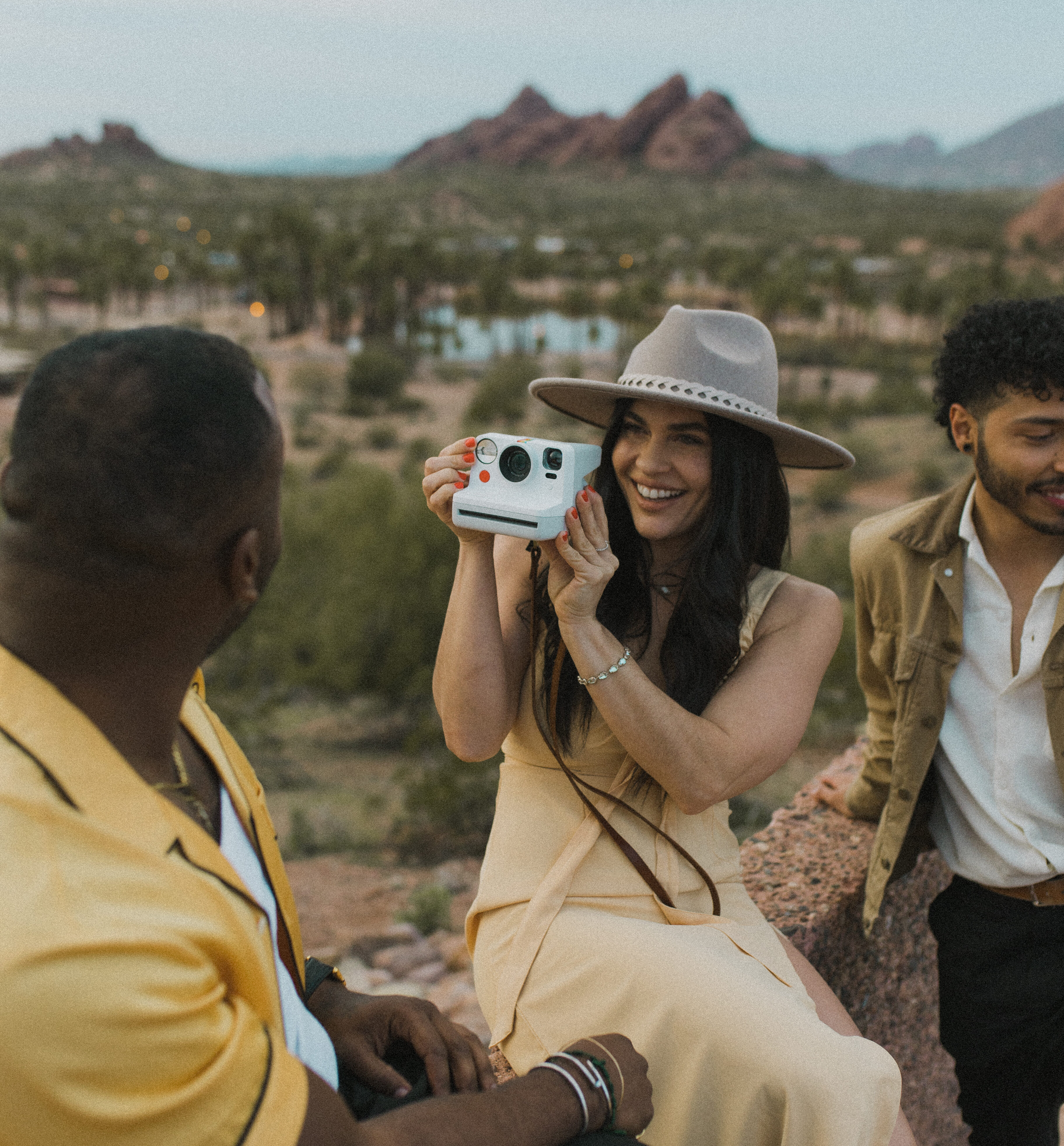 Girl taking a photo with a camera with Phoenix desert views