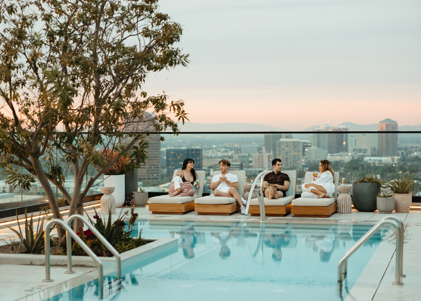 Residents laying by the pool at Moontower Phoenix Apartments