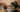 Two roommates clinking wine glass in their two-bedroom apartment